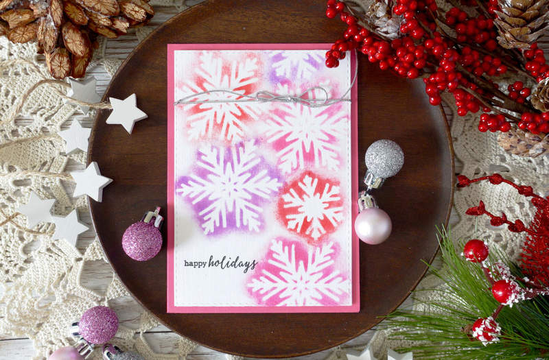 Handmade Christmas card. Using die cut snowflake as a stencil and distress ink to create a simple snowflake background.