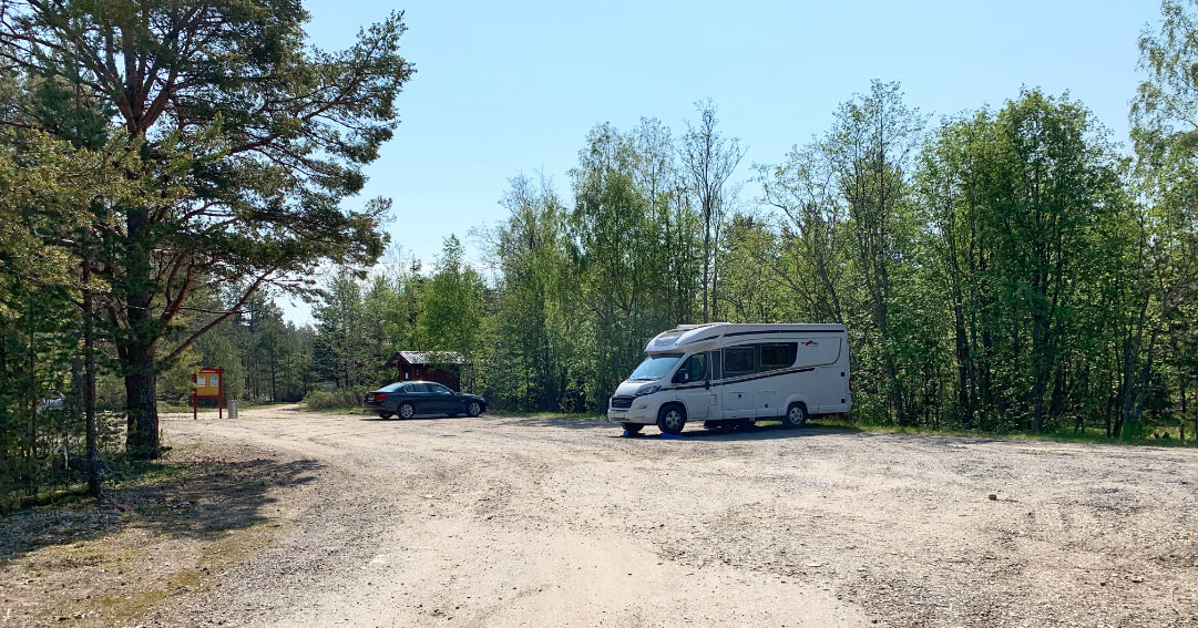View of our motorhome, the Malibu Carthago, parking at a camping lot close to a beach at the sea, close to the village Hörnefors.