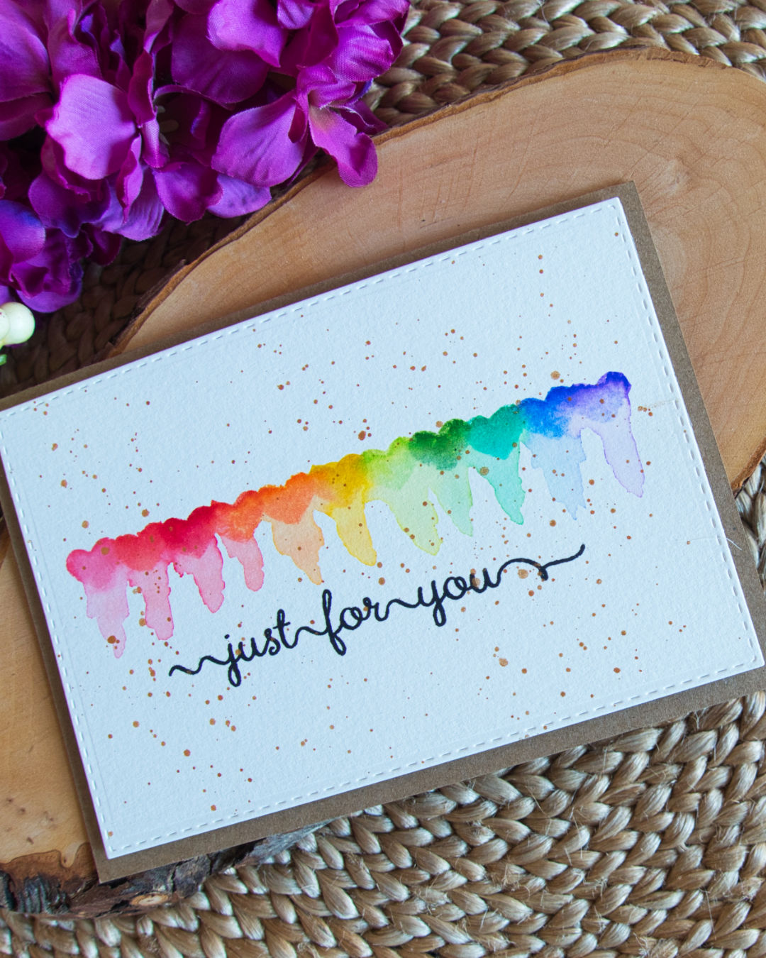 Card for Valentines day, with rainbow hearts with messy reflections using distress inks.