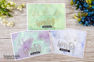Handmade Christmas Holiday Card with a beautiful watercoloured background and bokeh effect. In addition using small tree die and winter die from Neat &amp; Tangled.