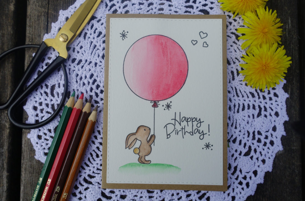 Happy Birthday card with a bunny holding a balloon. Stamped using the stamp set from Avery Elle called Some Bunny and watercoloured using watercolouring pencils from Faber Castel.