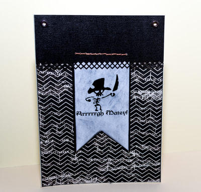 Handmade card for boys and men, with a printed pirate. Using pattern paper and distress ink to create a masculine look.
